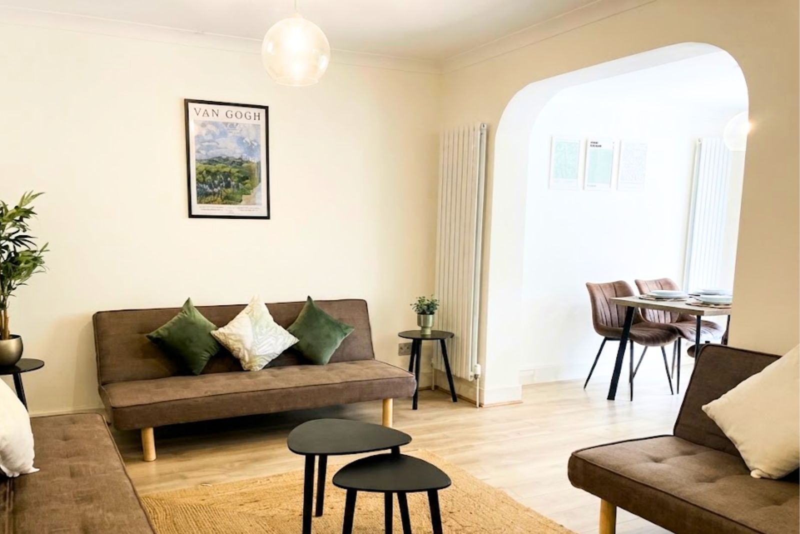 Living room with two sofas and an arch through to the dining area