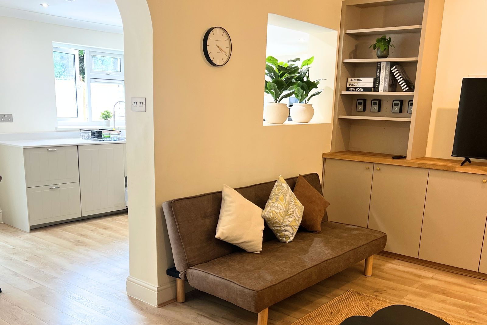 Living room with sofa, shelving and TV
