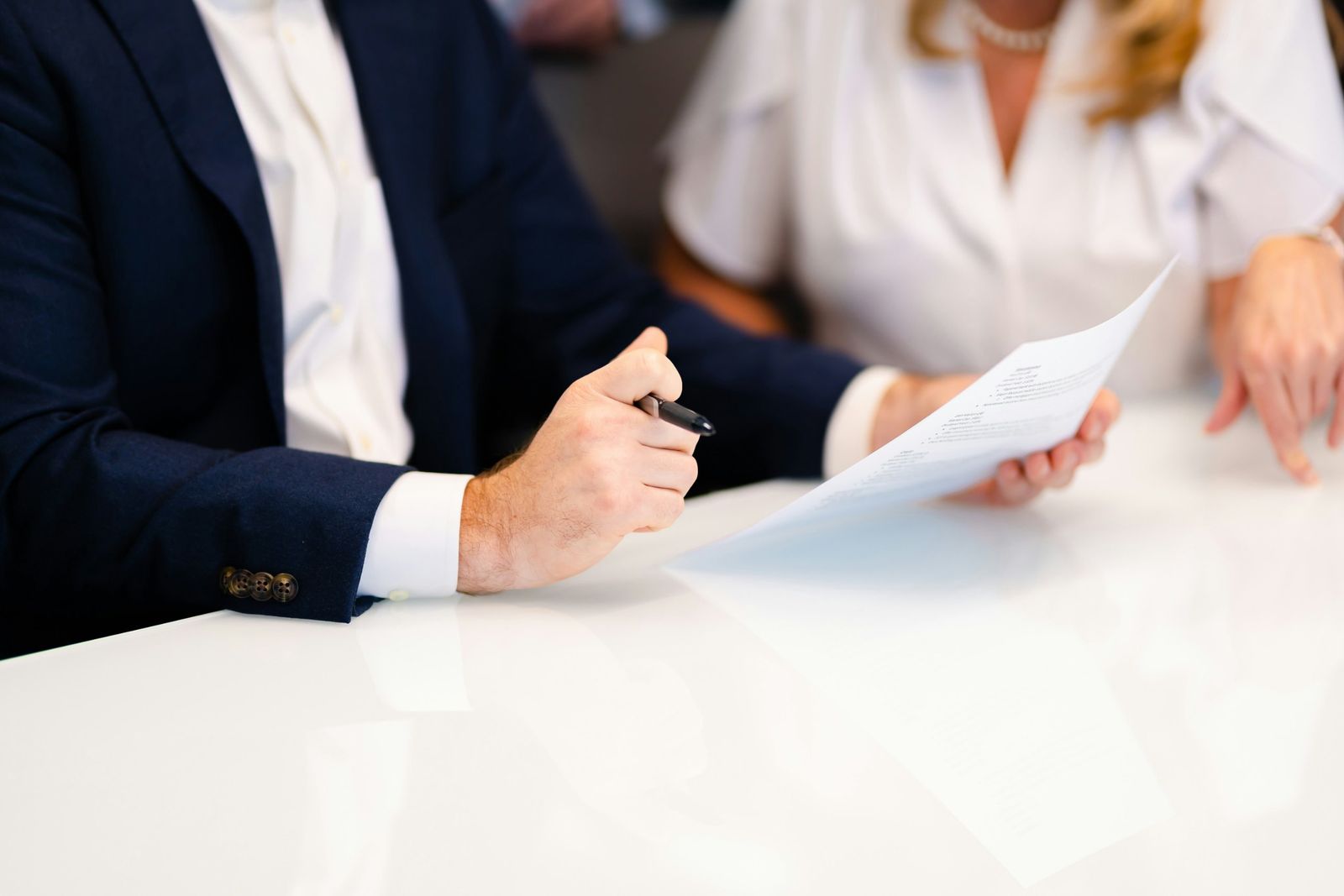Two people reviewing an agreement at a table