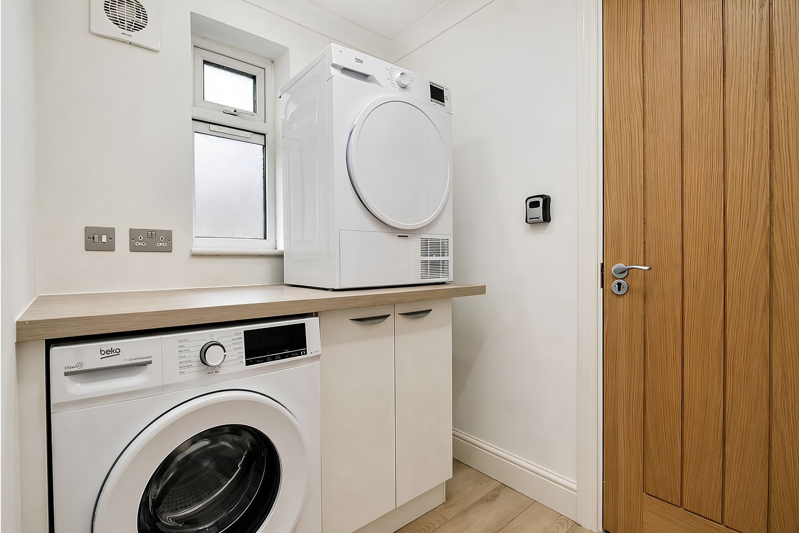 Utility room with washing machine and tumble dryer